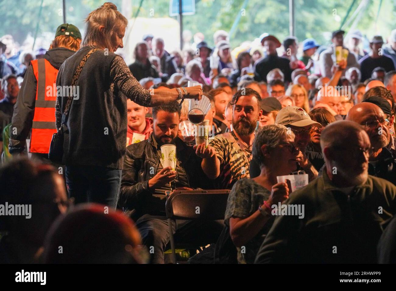 Glanusk Park, UK. Friday, 18 August, 2023. Festival goers at a beer tasting talk on a rainy day 2 at the 2023 Green Man Festival in Glanusk Park, Brecon Beacons, Wales. Photo date: Friday, August 18, 2023. Photo credit should read: Richard Gray/Alamy Live News Stock Photo