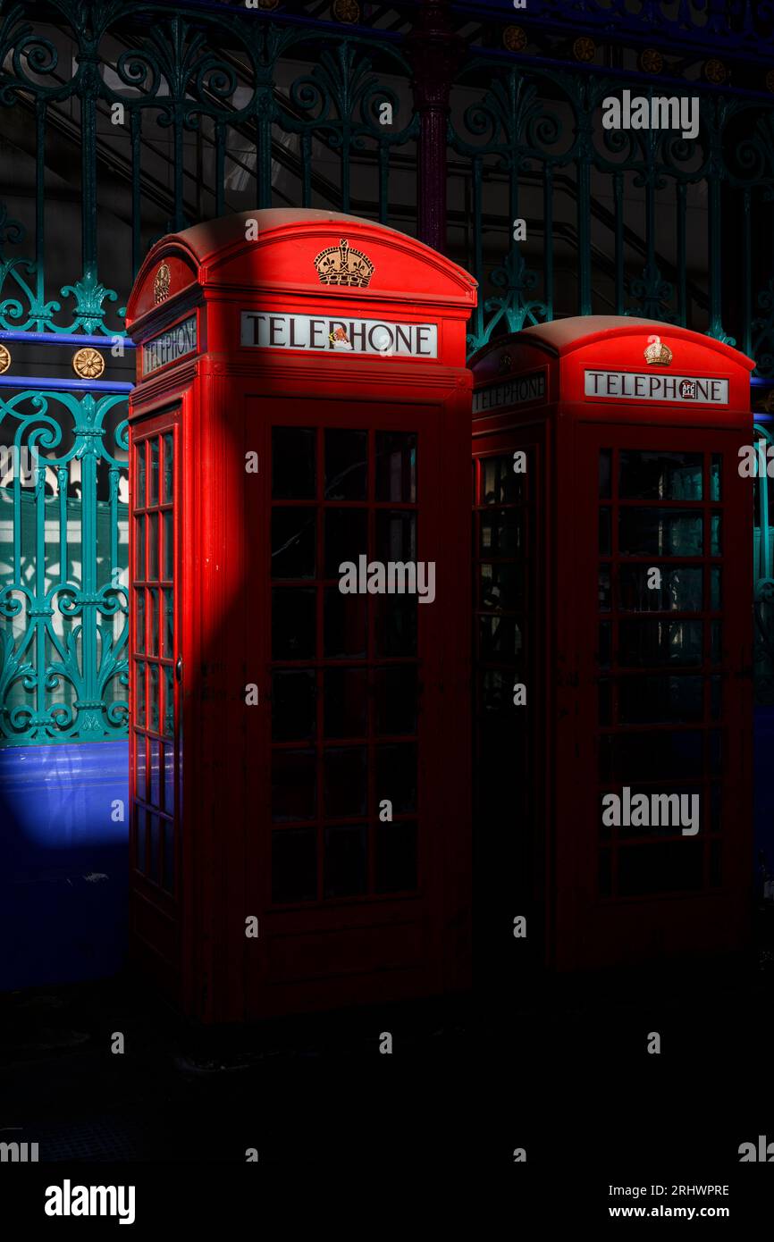 A row of two historic red phone boxes in Smithfield Meat Market - the smaller of them is the K6 design and the other is the K2 design, both created by Stock Photo