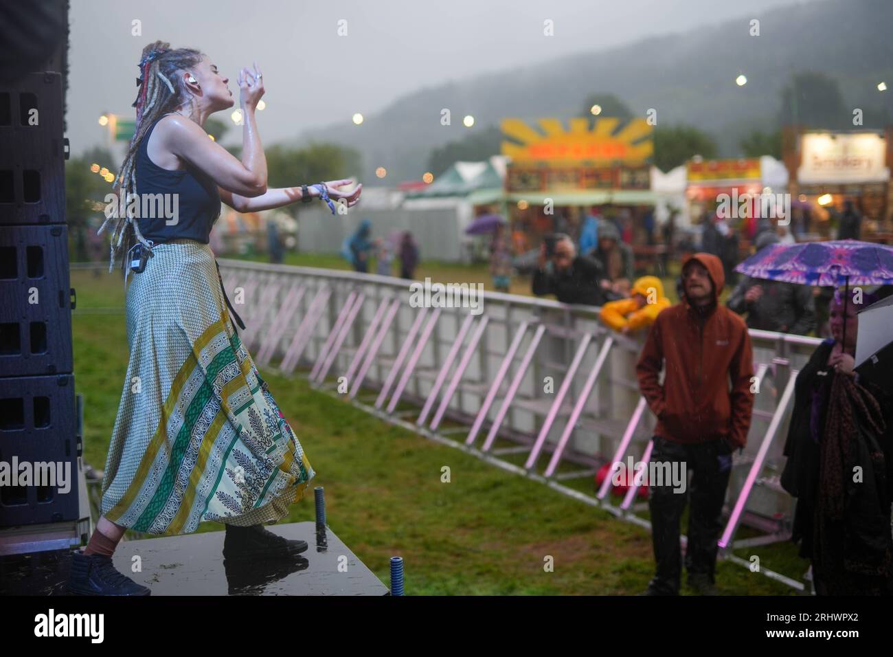 Glanusk Park, UK. Friday, 18 August, 2023. A signer during a performance on a rainy day 2 at the 2023 Green Man Festival in Glanusk Park, Brecon Beacons, Wales. Photo date: Friday, August 18, 2023. Photo credit should read: Richard Gray/Alamy Live News Stock Photo