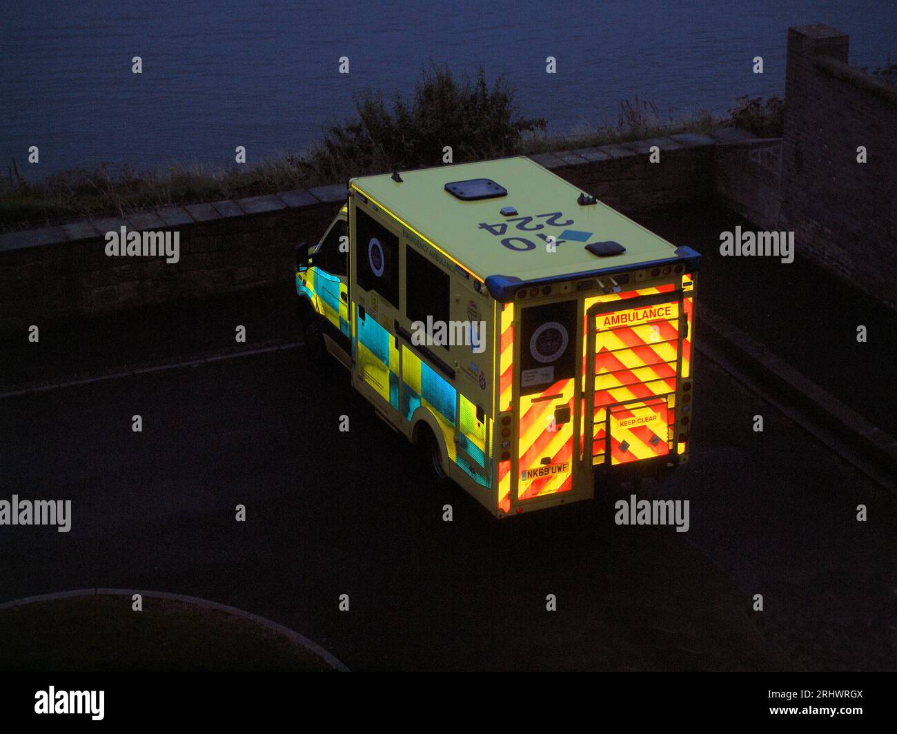 NHS 'Northumberland Ambulance Service' attending to a home visit in a pedestrian area in North Tyneside on a very warm summers evenings. Stock Photo