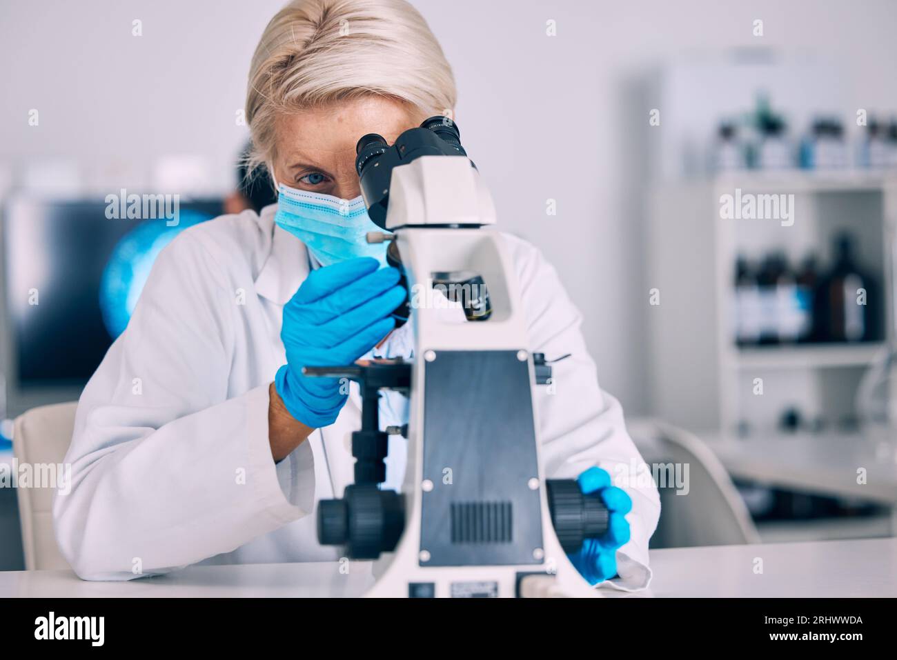 Microscope, senior woman and science check with vaccine research for a ...