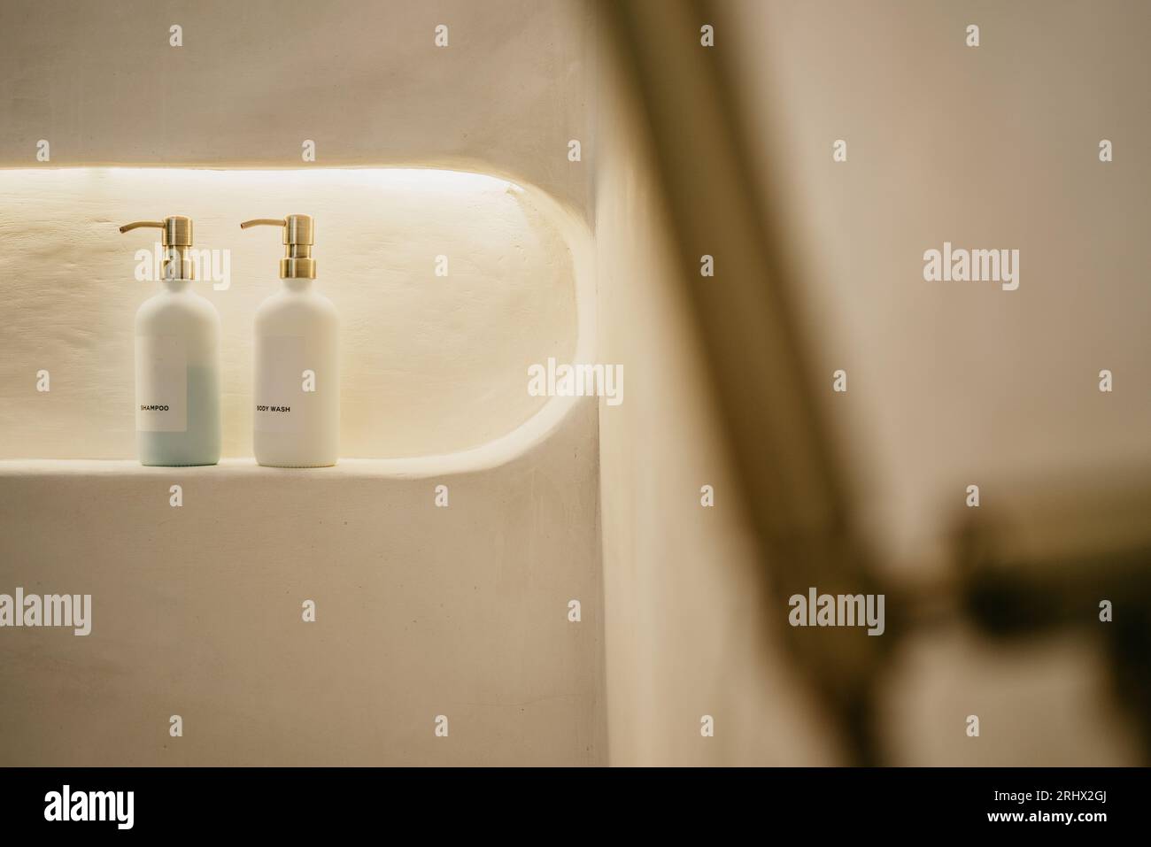 Selective focuse of Pump glass bottle with Liquid soap, shampoo, bath foam and accessories in bathroom. Stock Photo