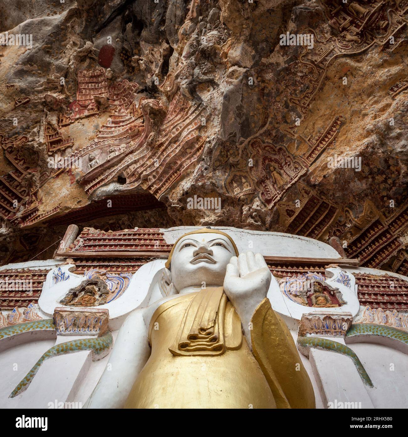 Buddha statue with carvings in Kaw Goon cave in Myanmar. Stock Photo