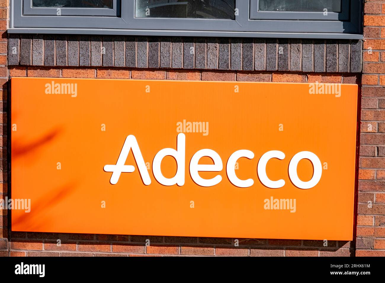 Adecco, recruitment agency, sign or logo on outside wall UK Stock 