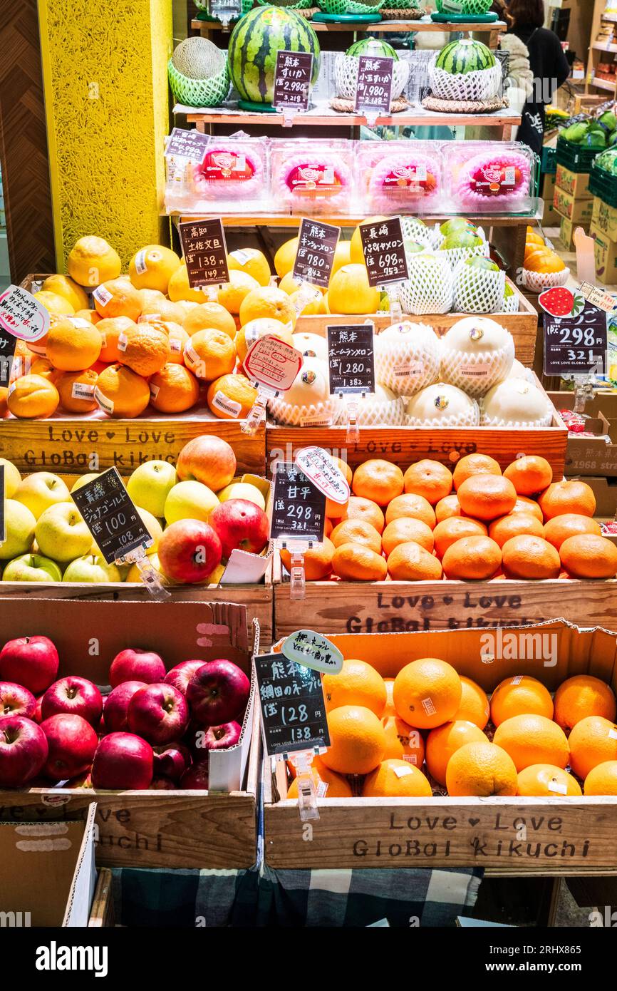 Display of various fruits on green grocer's stall outside a store in