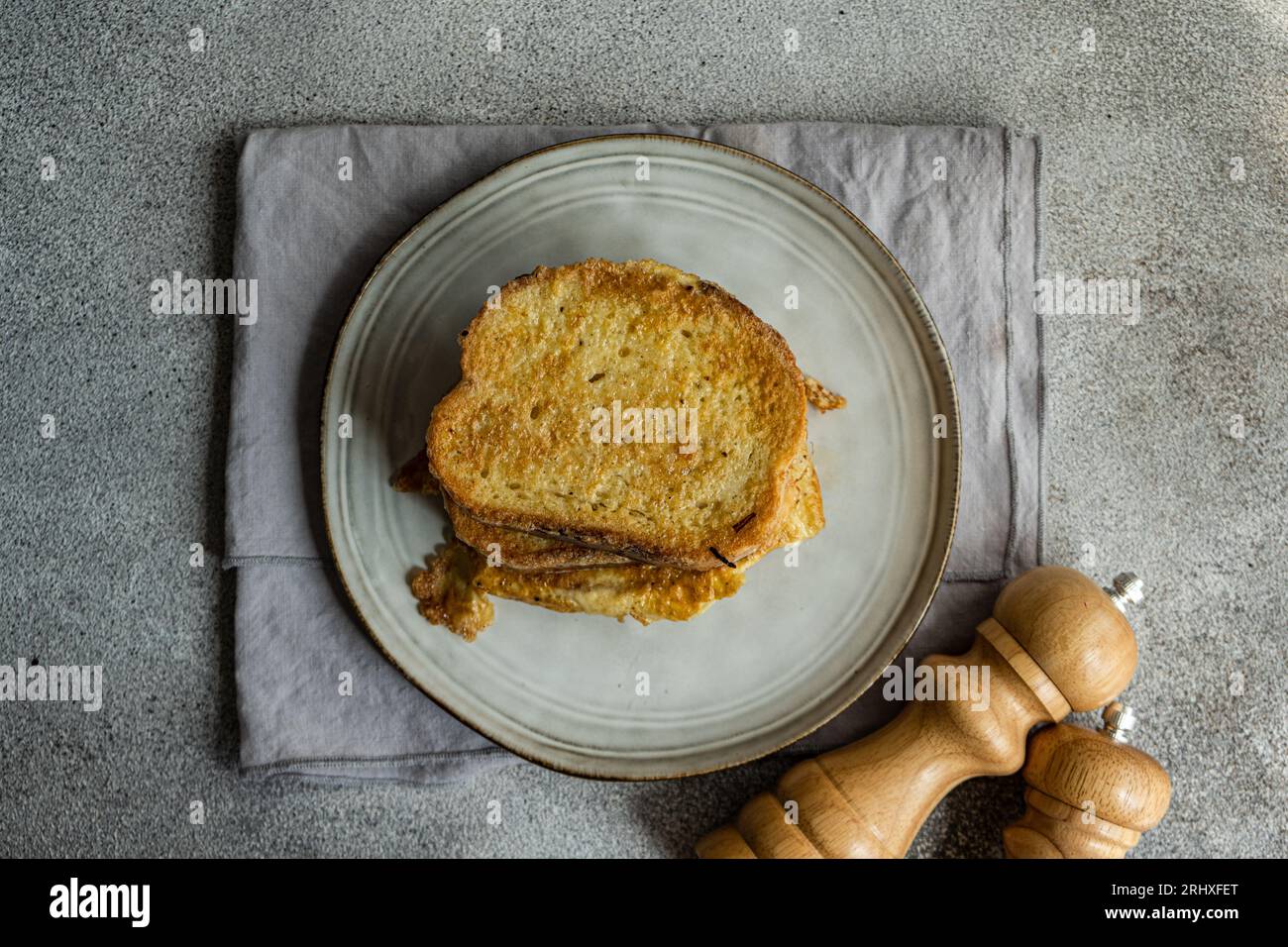 Top view of sliced of fried bread with egg coating on ceramic plate ...
