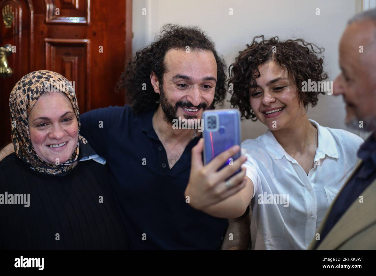 Cairo, Egypt. 19th Aug, 2023. Egyptian pro-democracy activist Ahmed Douma, who who has been imprisoned since December 2013, is welcomed by relatives following his release by a presidential pardon. Egyptian President Abdel-Fattah al-Sissi has pardoned several prisoners including prominent pro-democracy campaigner Ahmed Douma, a key figure in Egypt's 2011 popular uprising that forced long-time president Hosny Mubarak to step down, after spending nearly 10 years behind bars. Credit: Mohamed El Raai/dpa/Alamy Live News Stock Photo