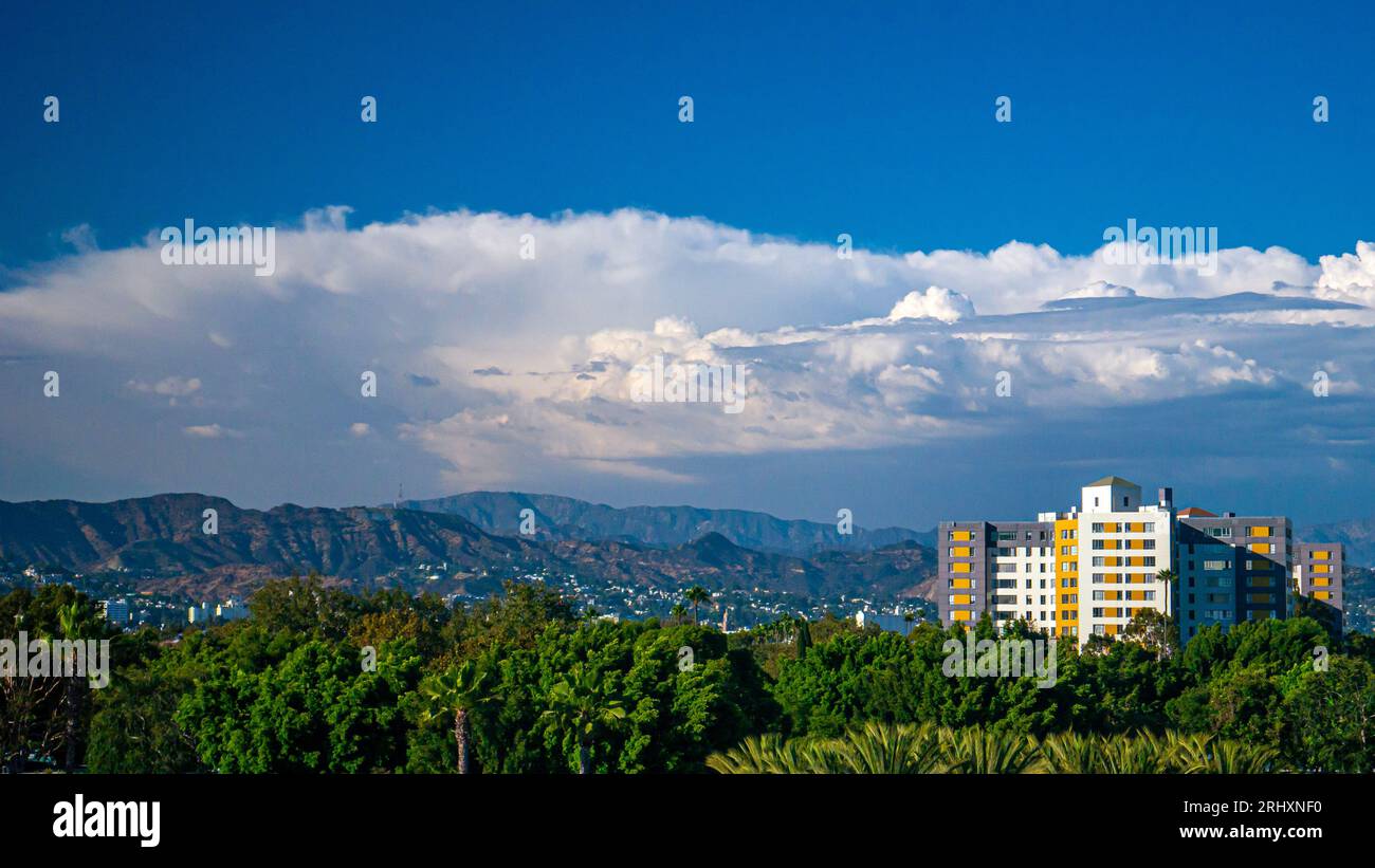 Modern apartment buildings rising above the mountains Stock Photo