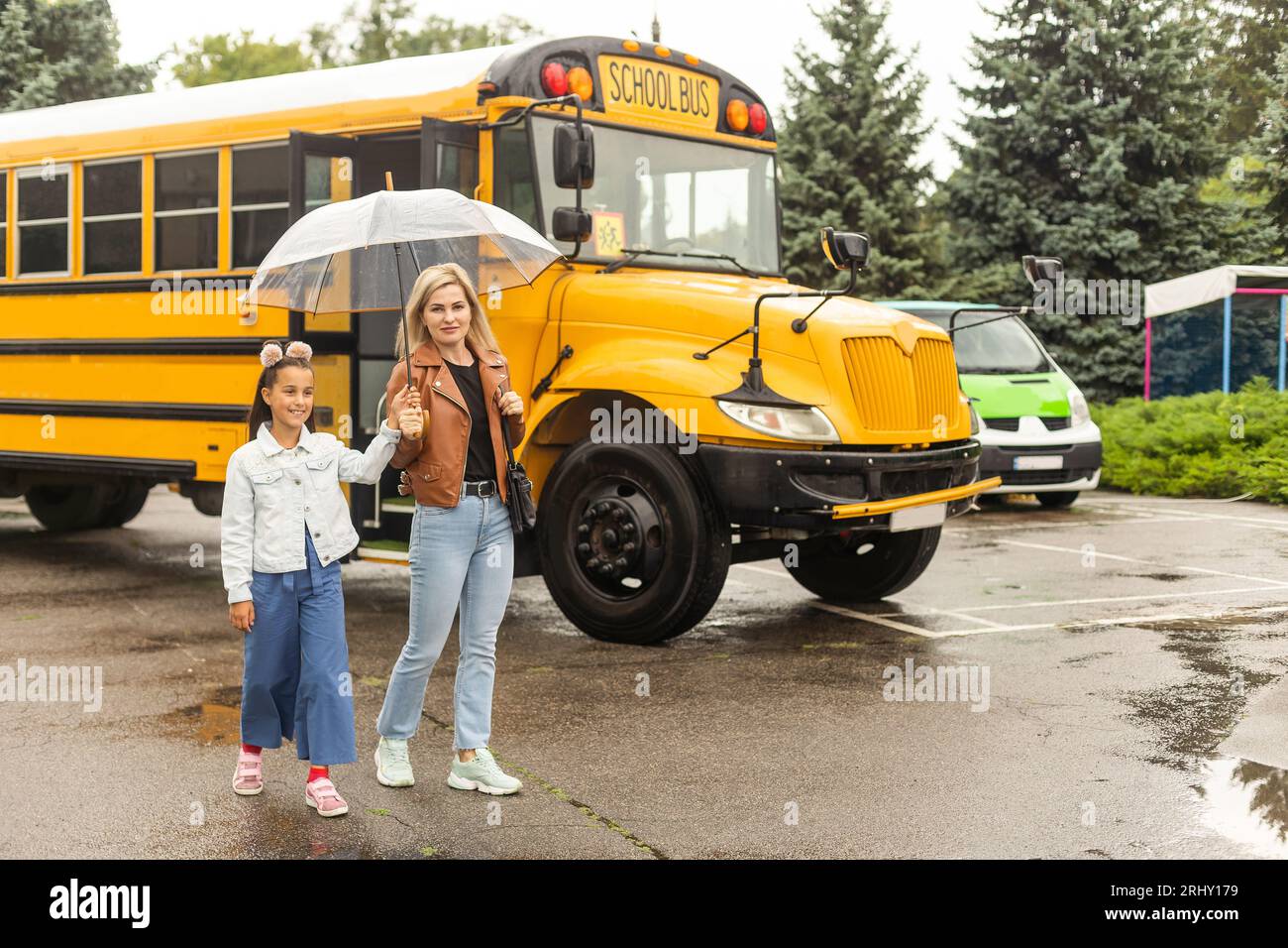 Education little girl and mother near school bus Stock Photo Alamy