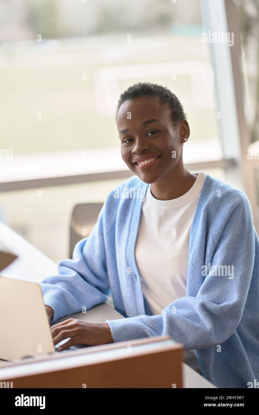 Happy African Black girl student using laptop computer. Vertical ...