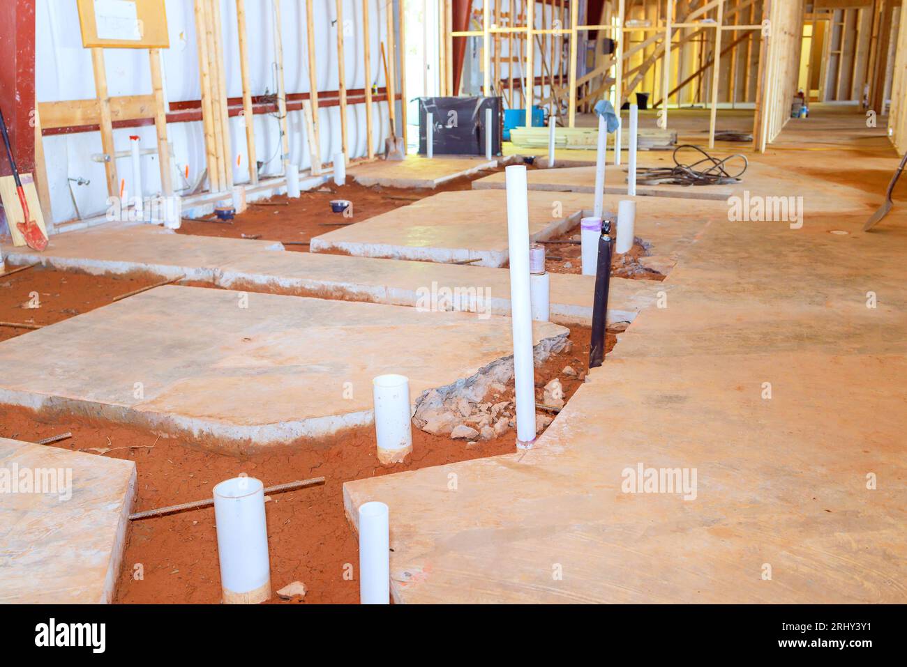 Plumbing preparation pvc pipe endings exposed in concrete floor for