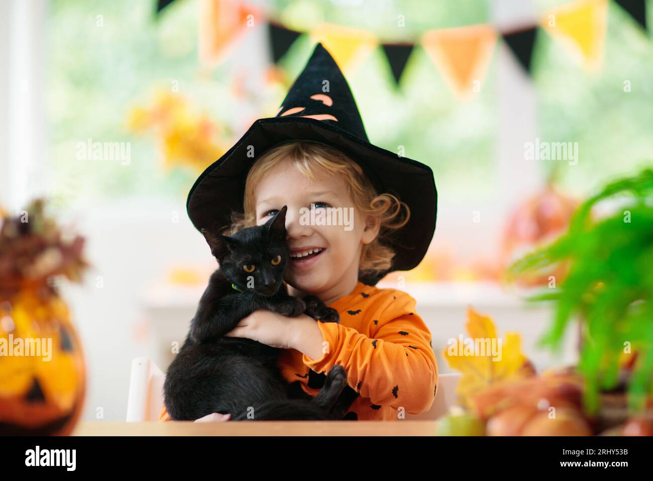 Child in Halloween costume. Kids trick or treat. Little boy and black ...