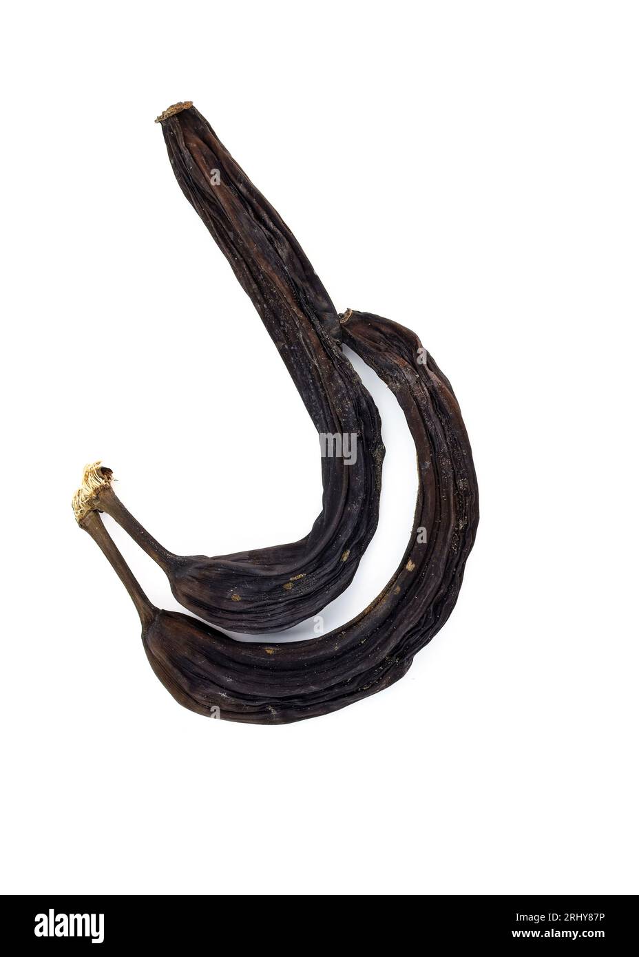 Two black dried bananas on a white background. old shriveled blackened bananas top view Stock Photo
