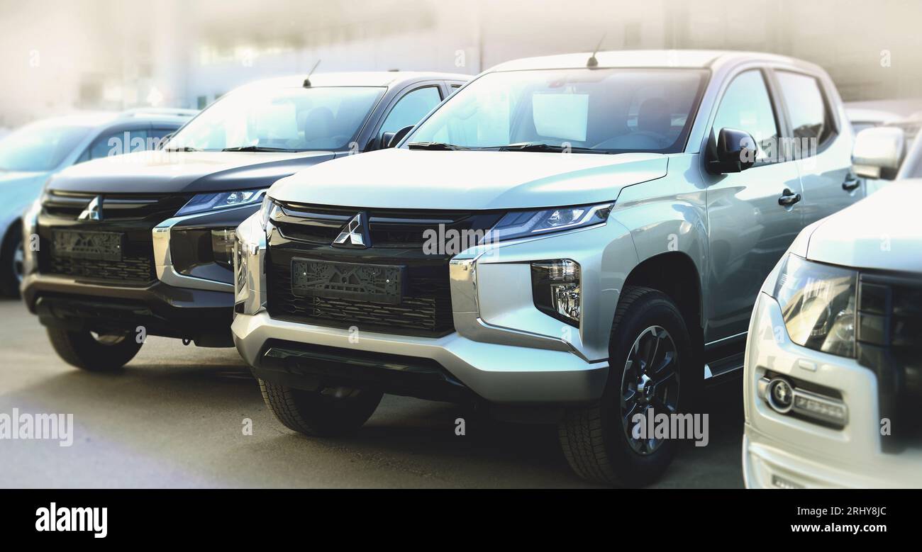 brand new pickups Mitsubishi L200 and Pajero parked outdoor in  car dealership Stock Photo