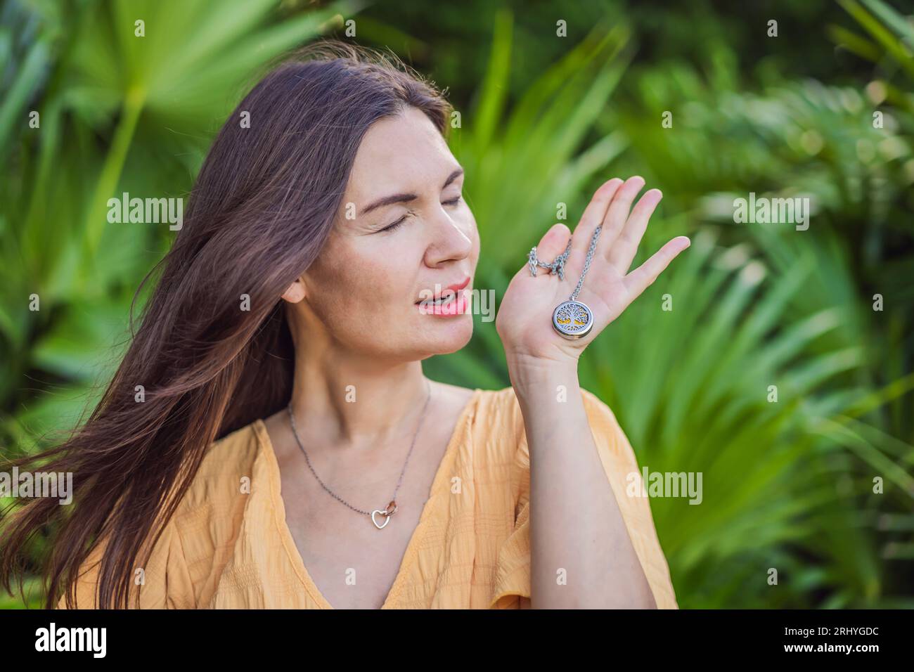 Picture of pregnant woman after 40 demonstrating the use of an aroma pendant ...