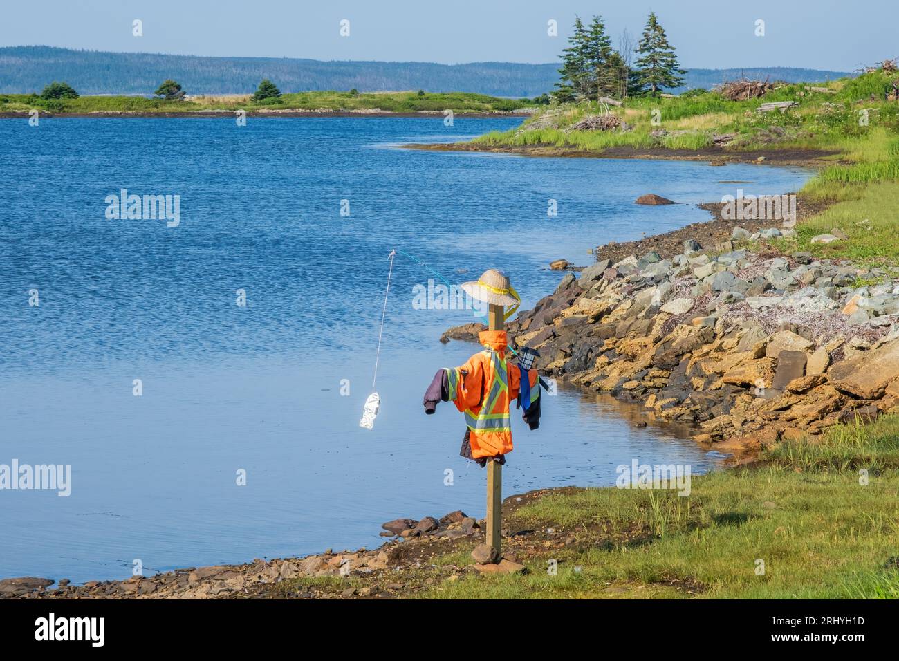 Local build a scarecrow type structure that appears to be fishing near the small village of Gabarus Nova Scotia. Stock Photo