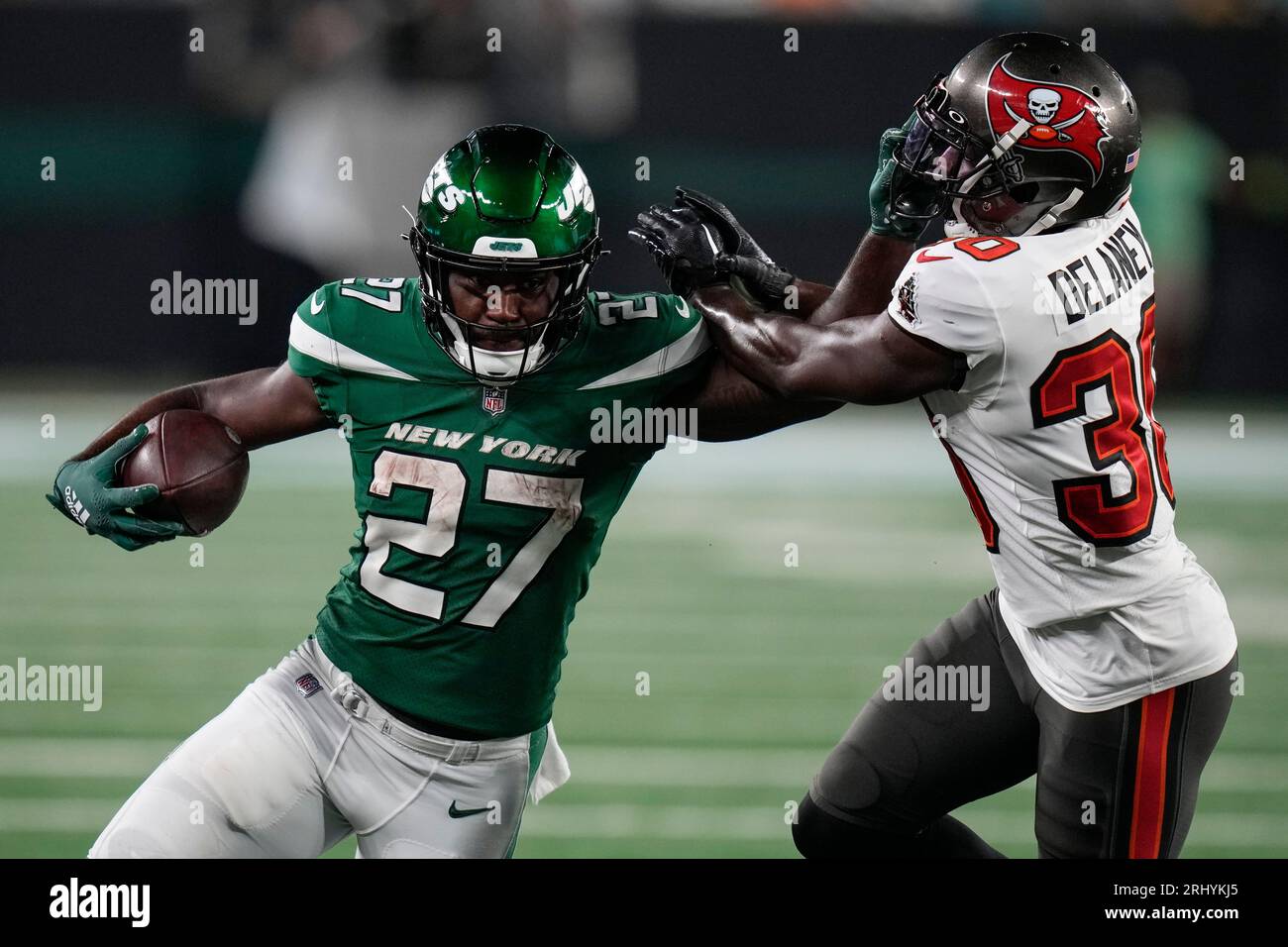 New York Jets running back Zonovan Knight (27) stiffarms Tampa Bay