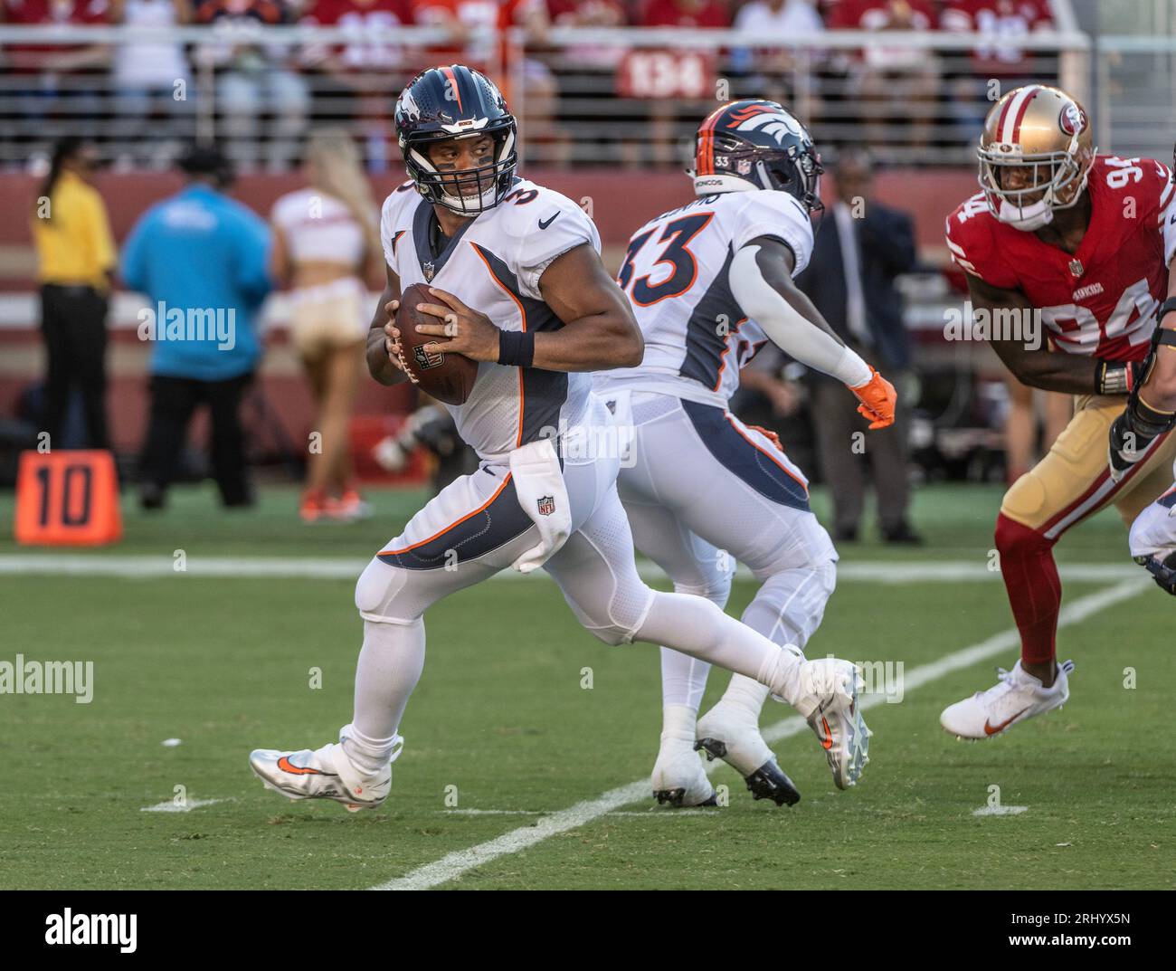 Denver Broncos quarterback Russell Wilson (3) is tackled by San Francisco  49ers defensive tackle Javon Hargrave (98) in thye first quarter at Levi's  Stadium in Santa Clara, California on Saturday, August 19