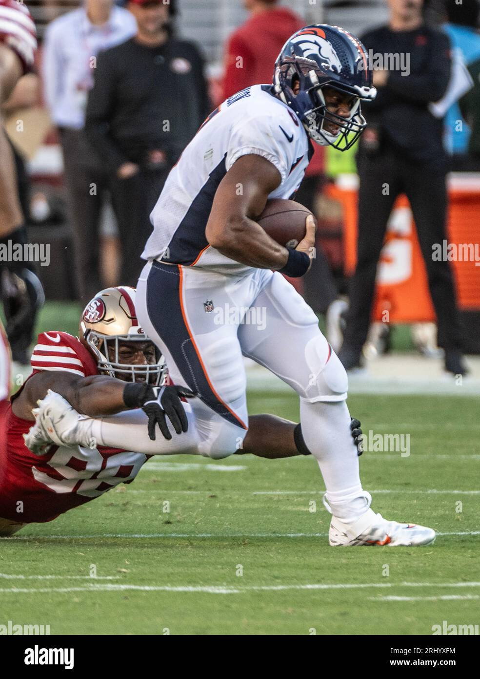 Denver Broncos quarterback Russell Wilson (3) is tackled by San
