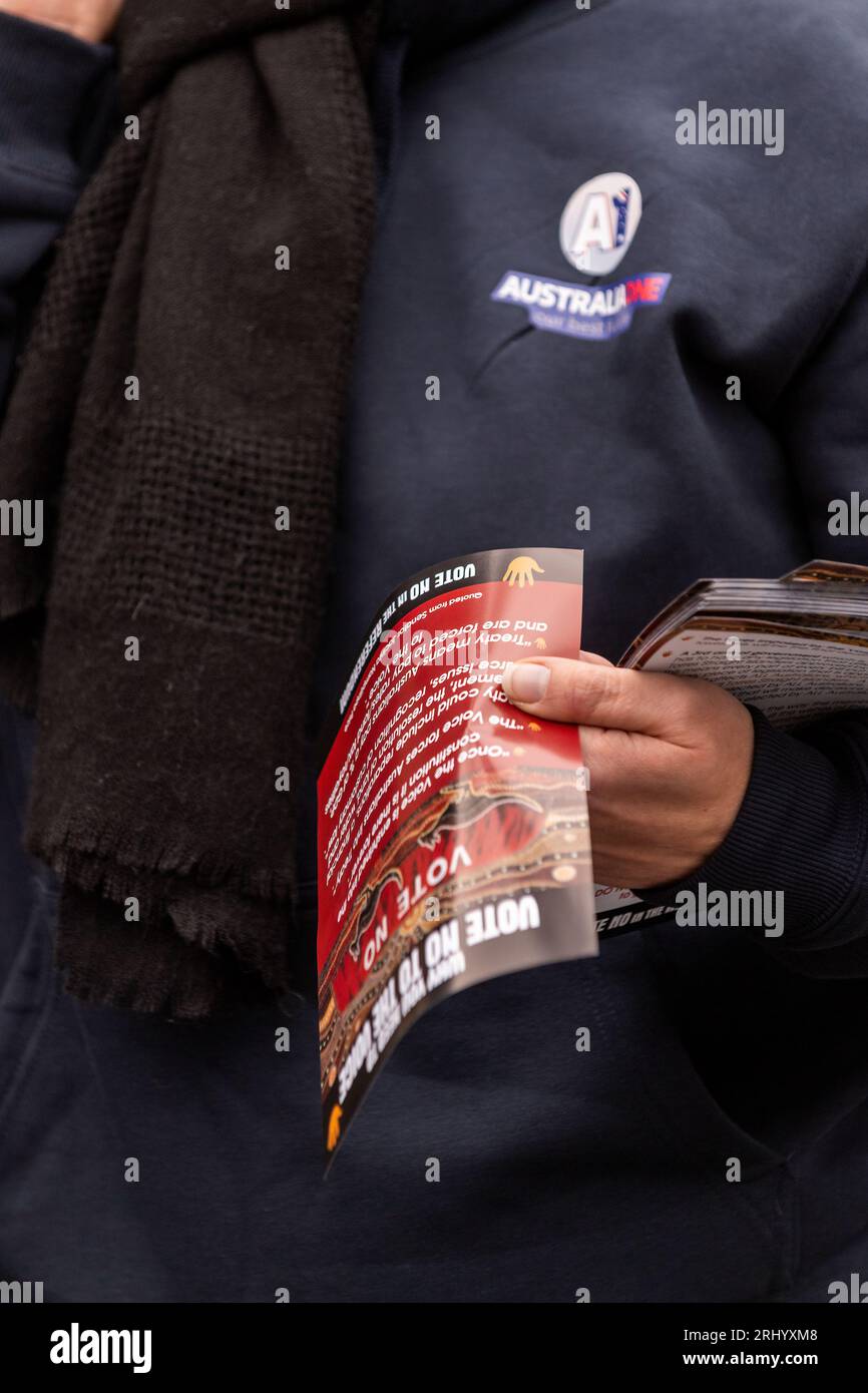 A protester hands out 'vote no' flyers during a rally on the steps of State Parliament. The Australian government will hold a referendum to change the constitution to include an indigenous 'voice to parliament'. A small group of around 30 people gathered in Melbourne at one of the first public rallies apposed to the voice. Speakers included indigenous people as well as member of fringe sovereign citizen movements and other fringe groups that emerged during the COVID-19 pandemic and lock-downs. (Photo by Michael Currie/SOPA Images/Sipa USA) Stock Photo