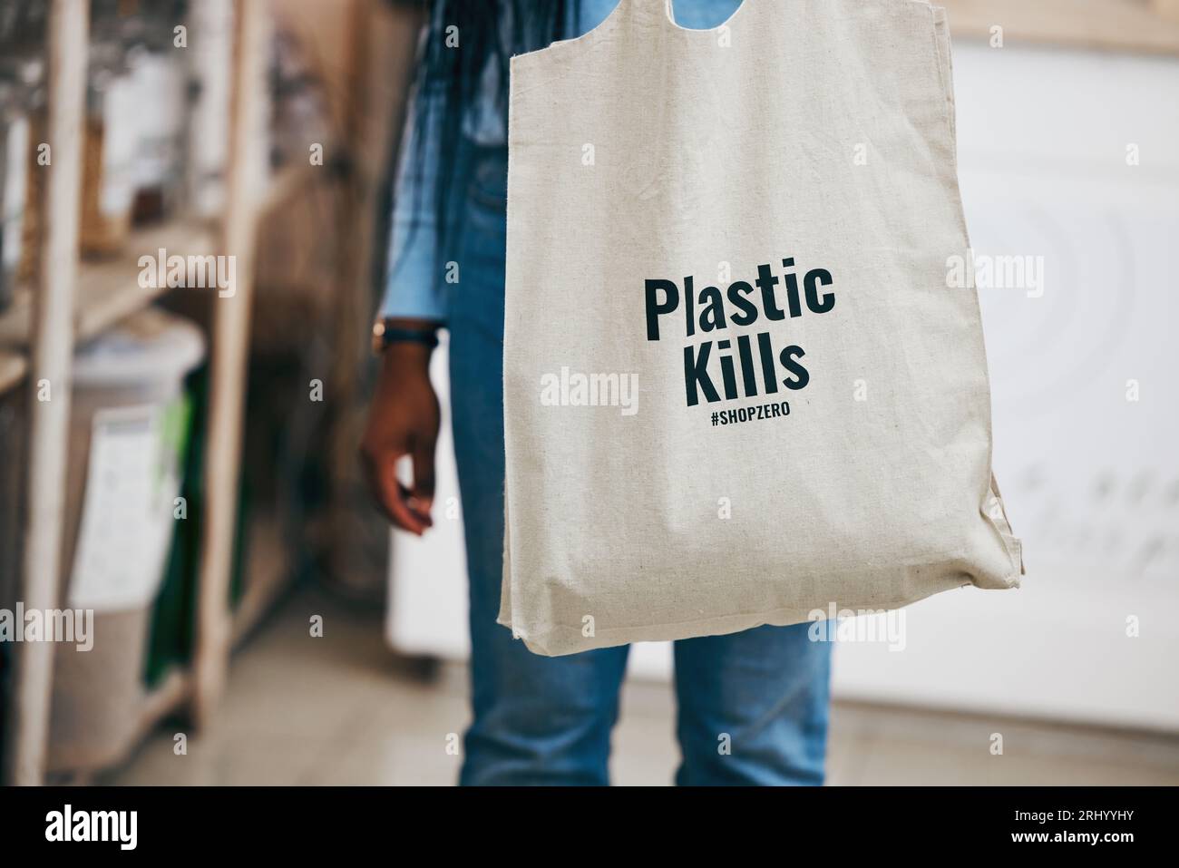 Person in eco friendly grocery store, recycling shopping bag and commitment to climate change at sustainable small business. Zero waste, plastic kills Stock Photo