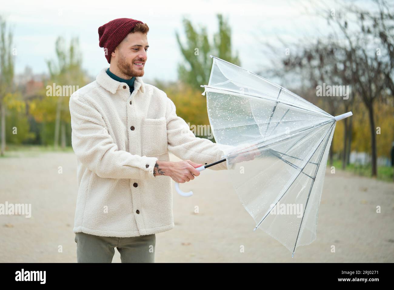 It Stops Raining Man closing umbrella hi-res stock photography and images - Alamy