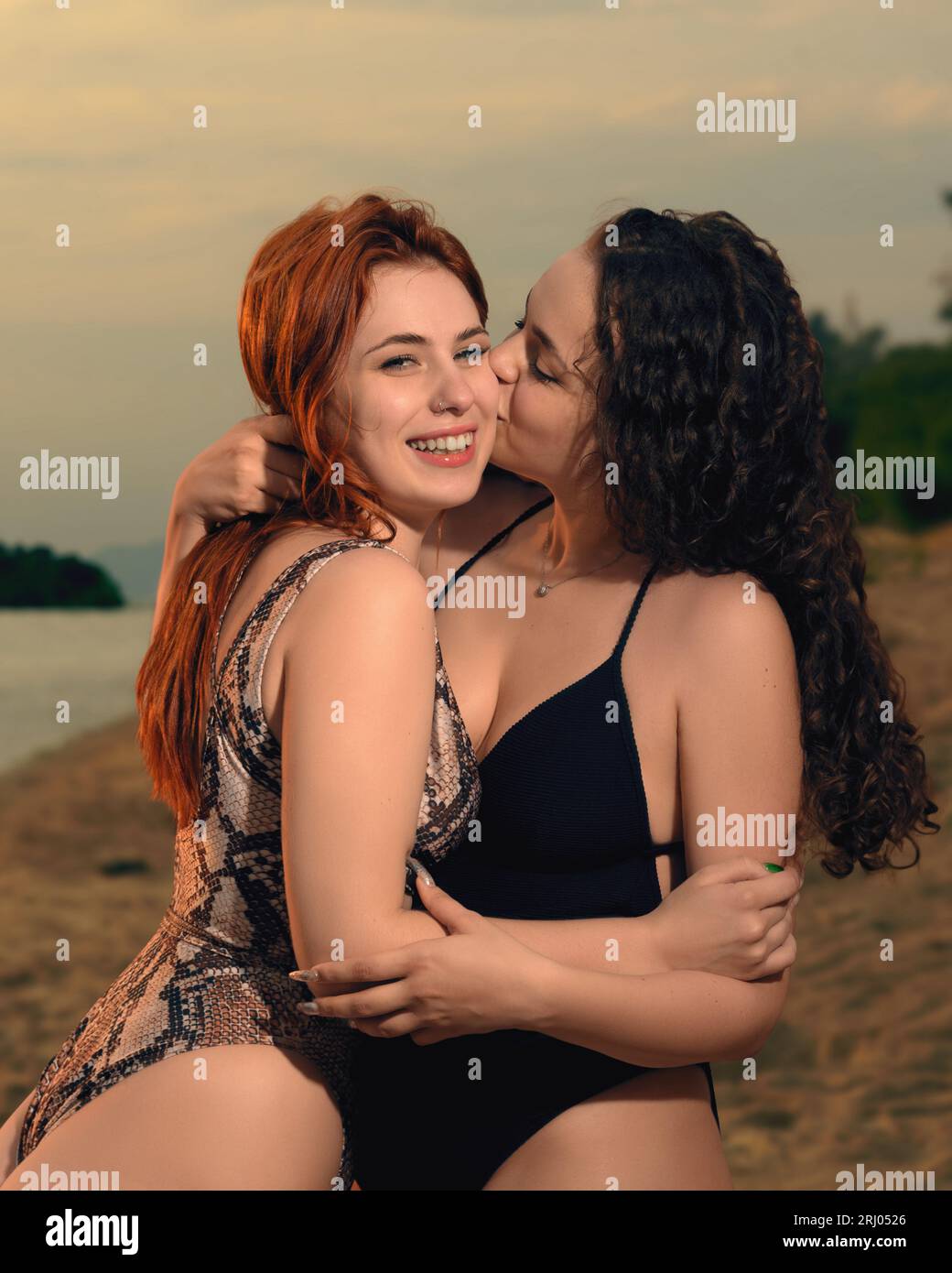 Young sexy lesbian couple enjoying life. Beautiful happy smiling women  embracing and kissing on the beach. Love, freedom, relationship, LGBT Stock  Photo - Alamy