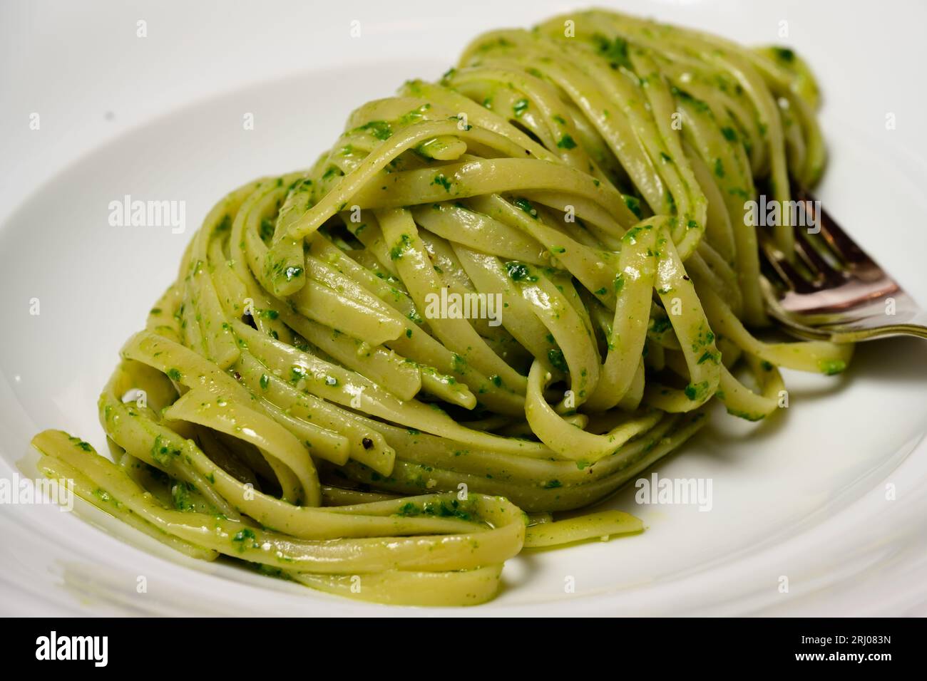 Trenette or Linguine Pasta with Green Pesto alla Genovese with Basil Stock Photo