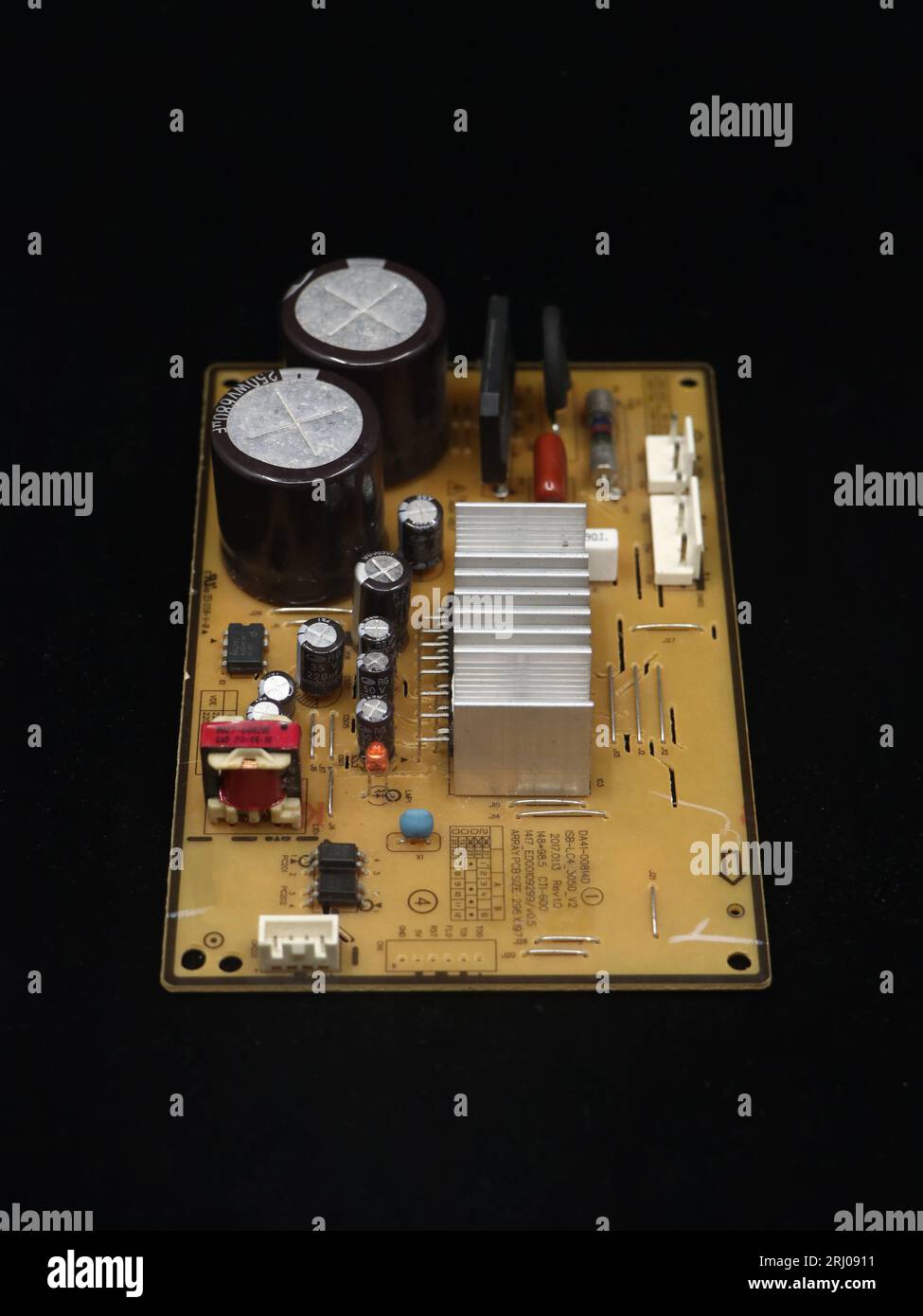 electronic components assembly on a power control inverter circuit motherboard used in electrical equipments isolated in a black background Stock Photo