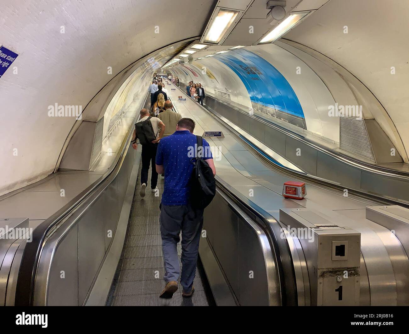 London, UK. 10th August, 2023. Passengers on a moving travelator at Bank tube station in the City of London. Many city workers use the Bank underground link from Waterloo Station. The tube to Bank is fondly known as the Drain. Credit: Maureen McLean/Alamy Stock Photo