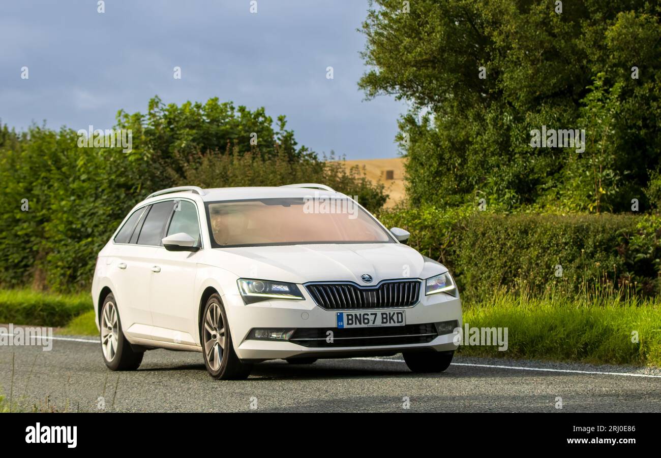 Woburn, Beds, UK - Aug 19th 2023:  2017 white diesel engine Skoda Superb car travelling on an English country road. Stock Photo