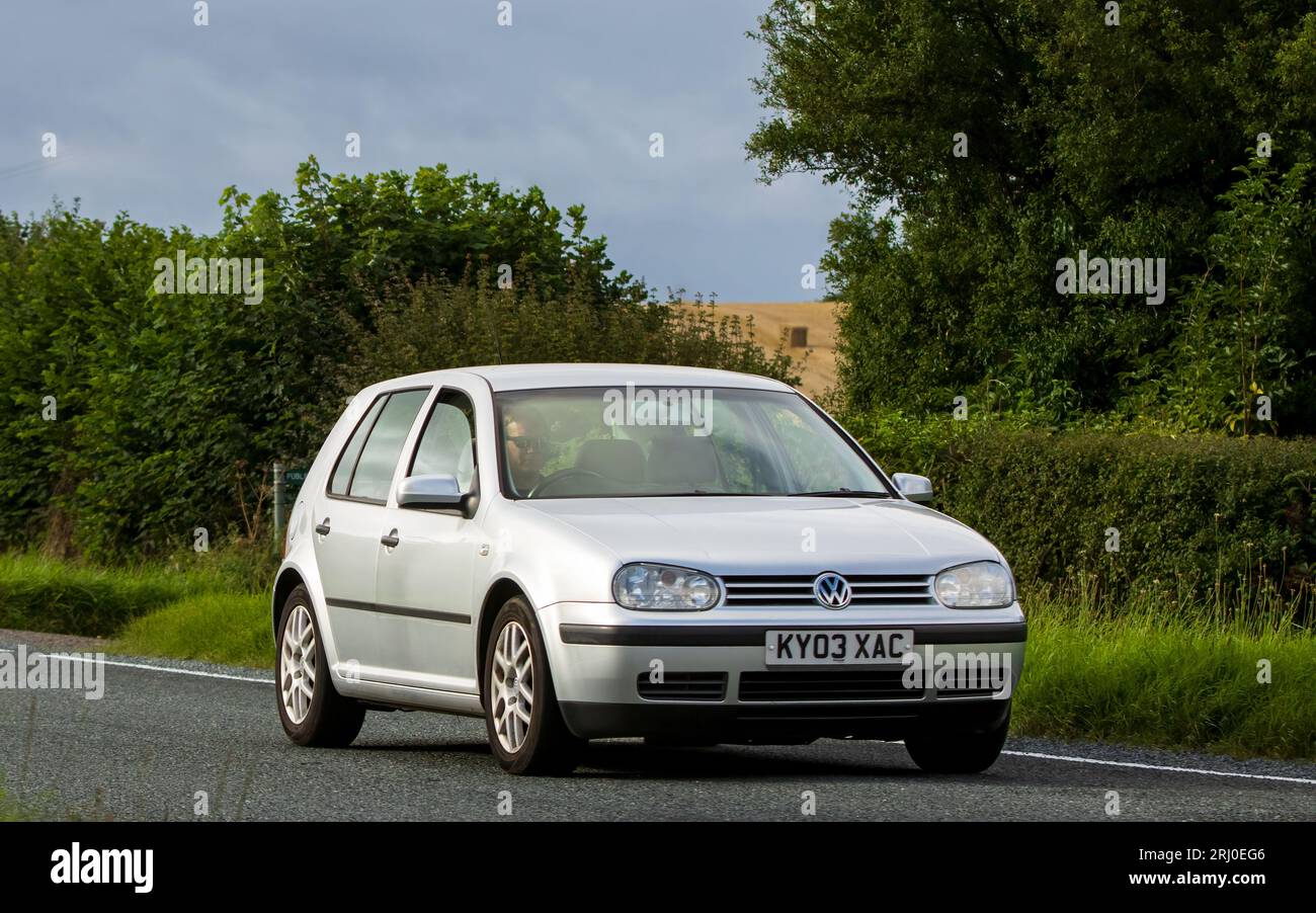 Woburn, Beds, UK - Aug 19th 2023:  2003 silver Volkswagen Golf hatchback car travelling on an English country road. Stock Photo