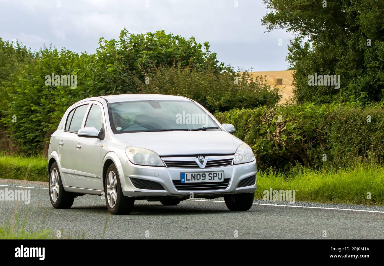 Woburn, Beds, UK - Aug 19th 2023: 2009 silver Vauxhall Astra  car travelling on an English country road. Stock Photo