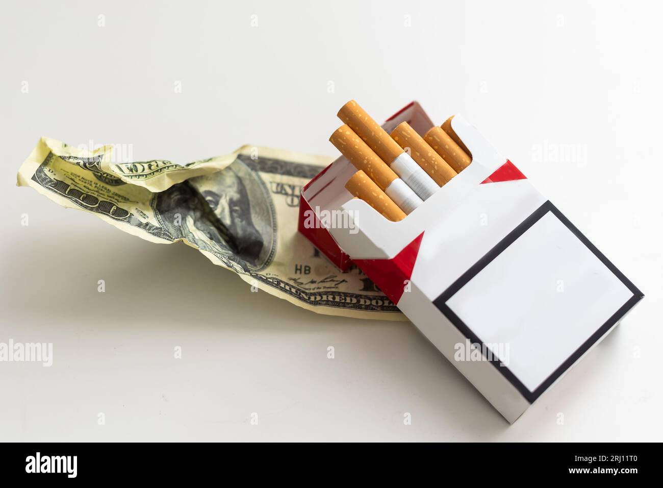 Cigarettes in the cigarette box over white background Stock Photo - Alamy