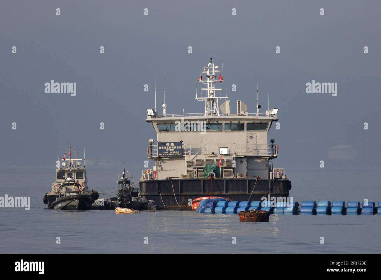 Tolo Barrier, barge, barrier, and police speedboats, Police Check Point, Tolo Harbour, New Territories Hong Kong, China 14 August 2023 Stock Photo