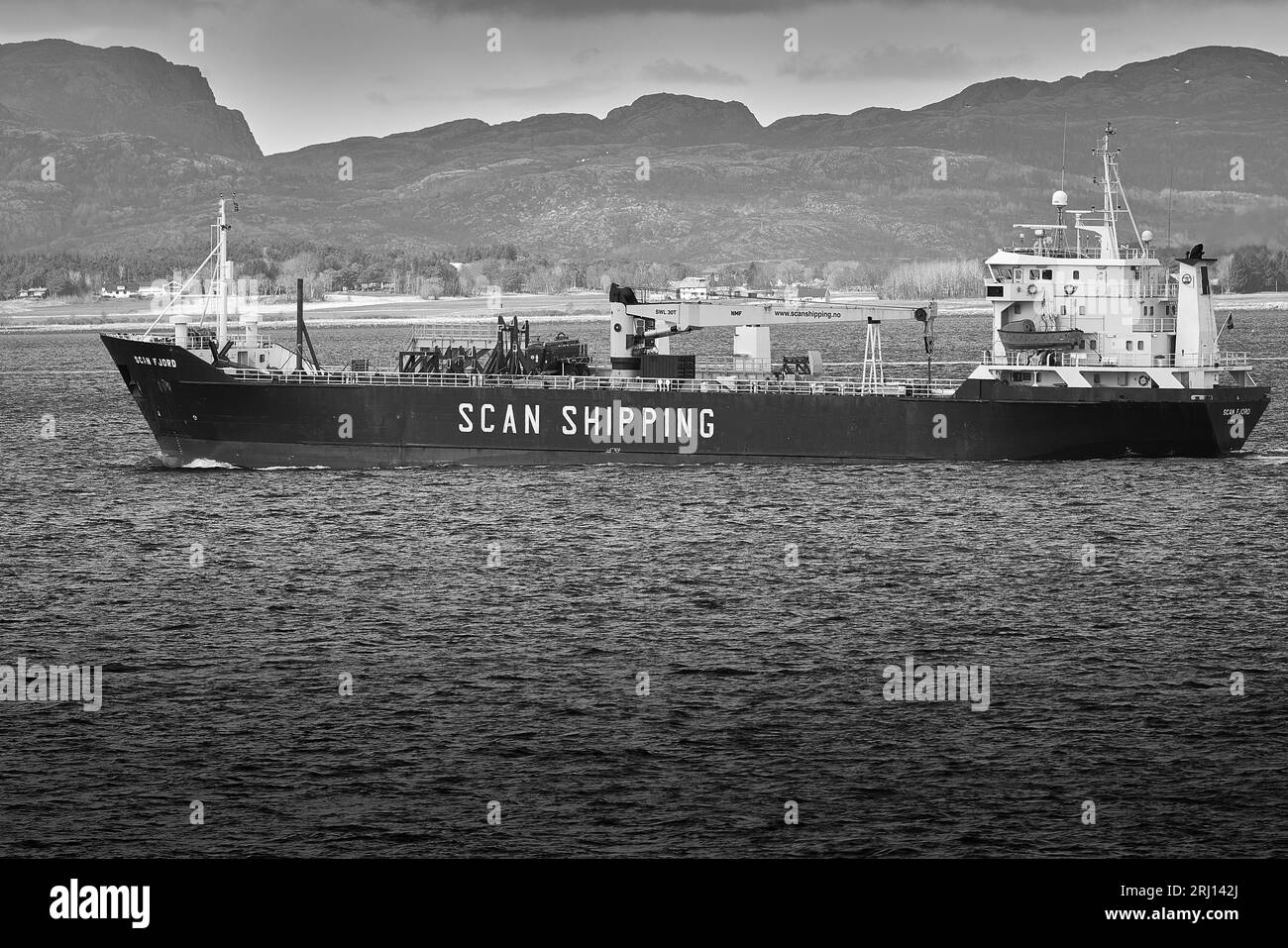 Black And White Photo Of The Scan Shipping Cargo/Container Ship, SCAN FJORD, Underway At The Mouth Of The Trondheim Fjord (Trondheimsfjorden), Norway Stock Photo