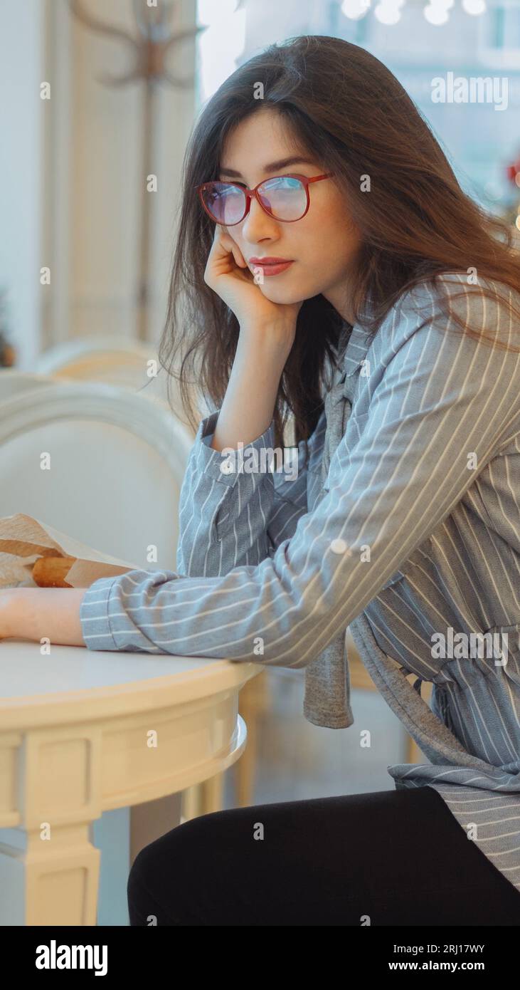 Angry woman sitting in the cafe waiting for someone Stock Photo