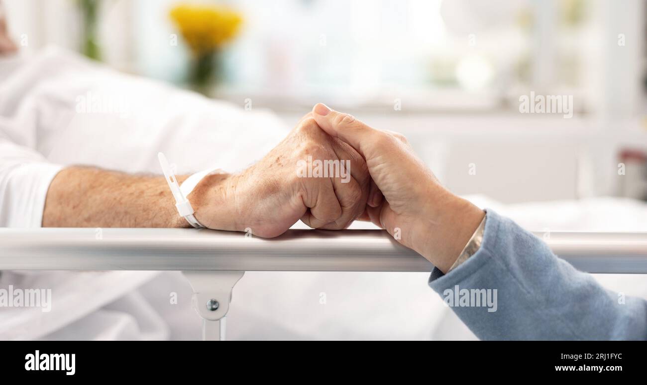 Sick Partner Hospital bed partner holding hands hi-res stock photography and images ...