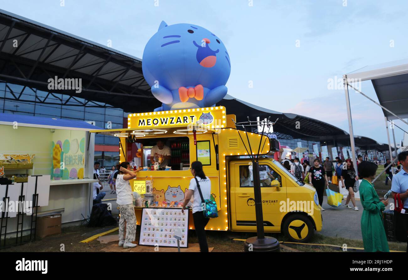 SHANGHAI, CHINA - AUGUST 18, 2023 - A cartoon inflatable doll sits on top of a caravan during the Tmall Night Extravaganza at Pet Expo Asia in Shangha Stock Photo