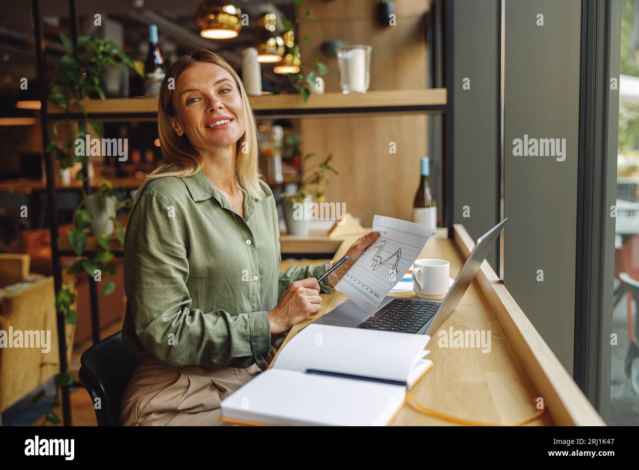 Analyst Software Window Woman analyst working with documents and use laptop while sitting in ...