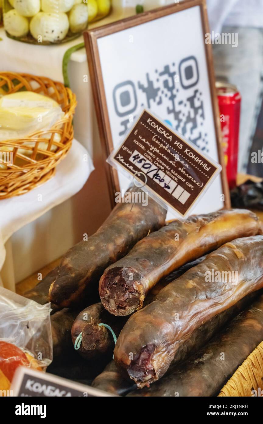 Istra, Russia - August 4, 2023. Smoked sausage and other farm delicacies from the manufacturer are on the counter. Meat products are ready for sale at Stock Photo