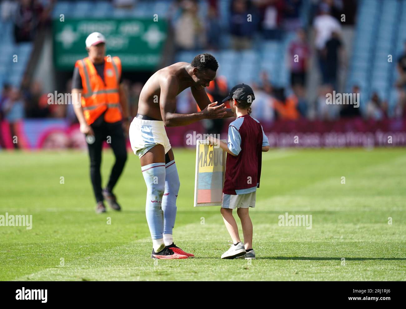 Aston Villa's Jhon Duran gives his shirt to a young fan following the