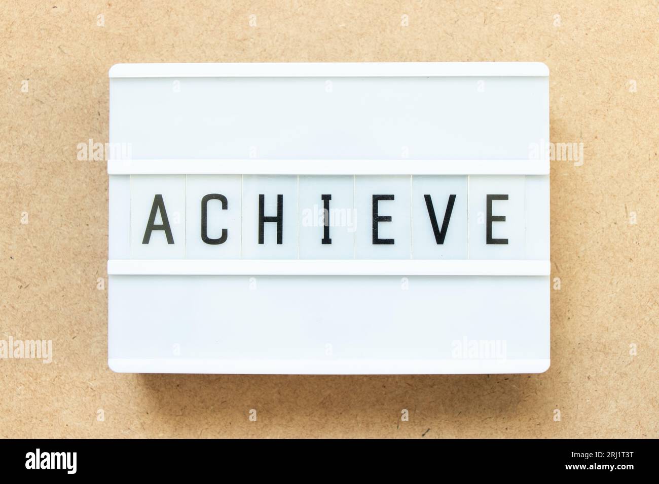 Lightbox with word achieve on wood background Stock Photo
