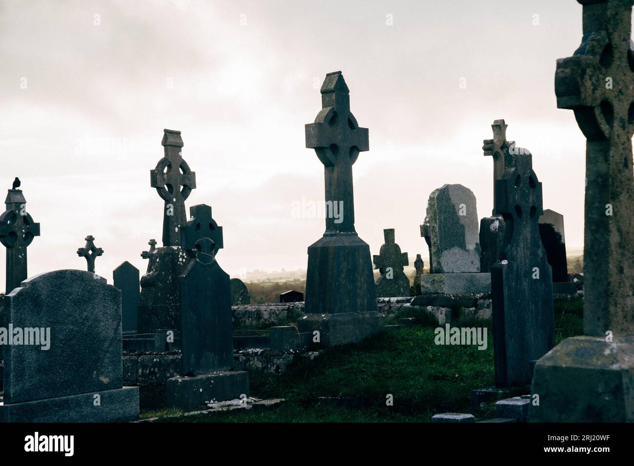 Old Cemetery in Ireland with Celtic Cross Gravestones and Dark Clouds ...
