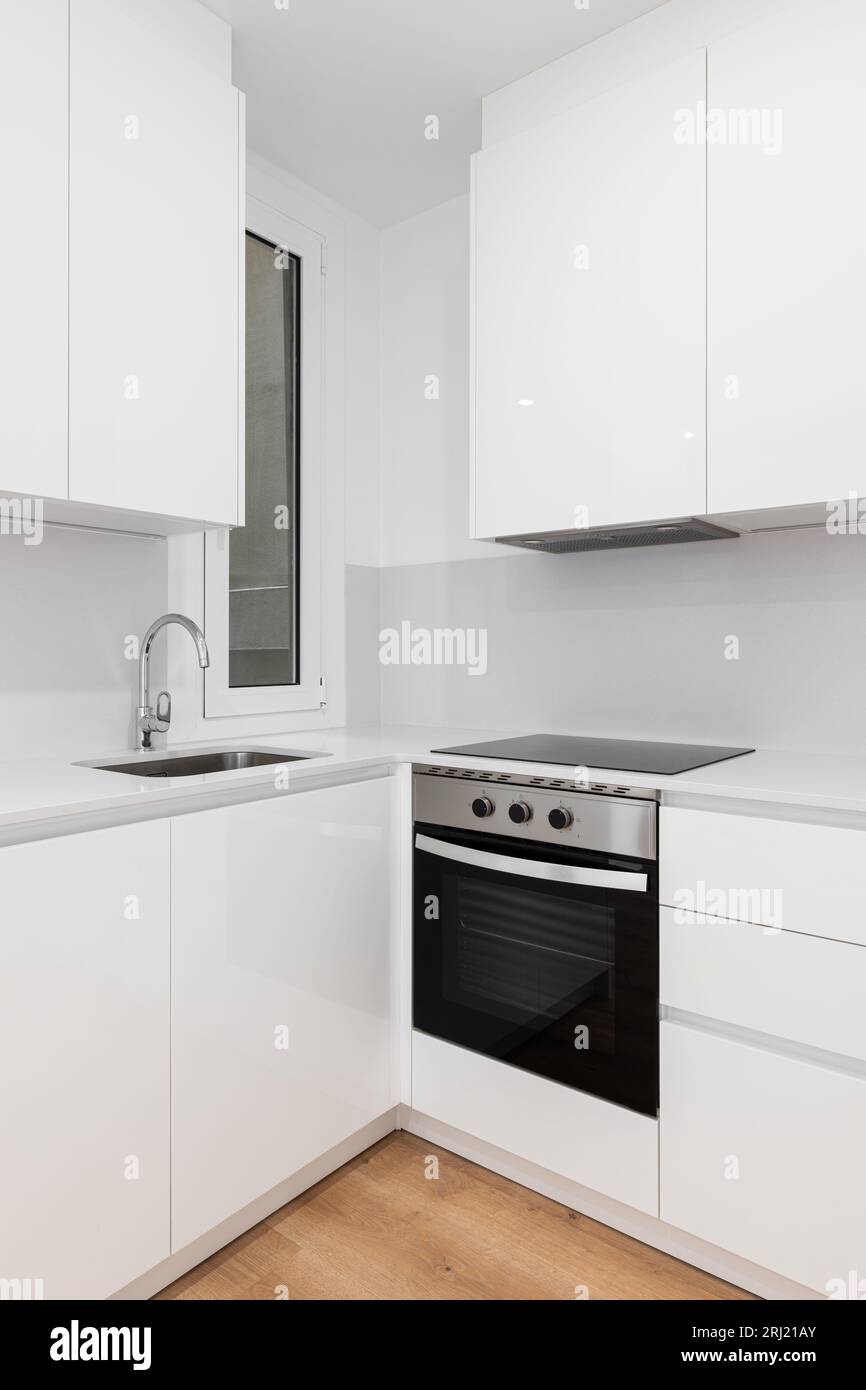 Modern white kitchen with sleek and a stylish black stove top