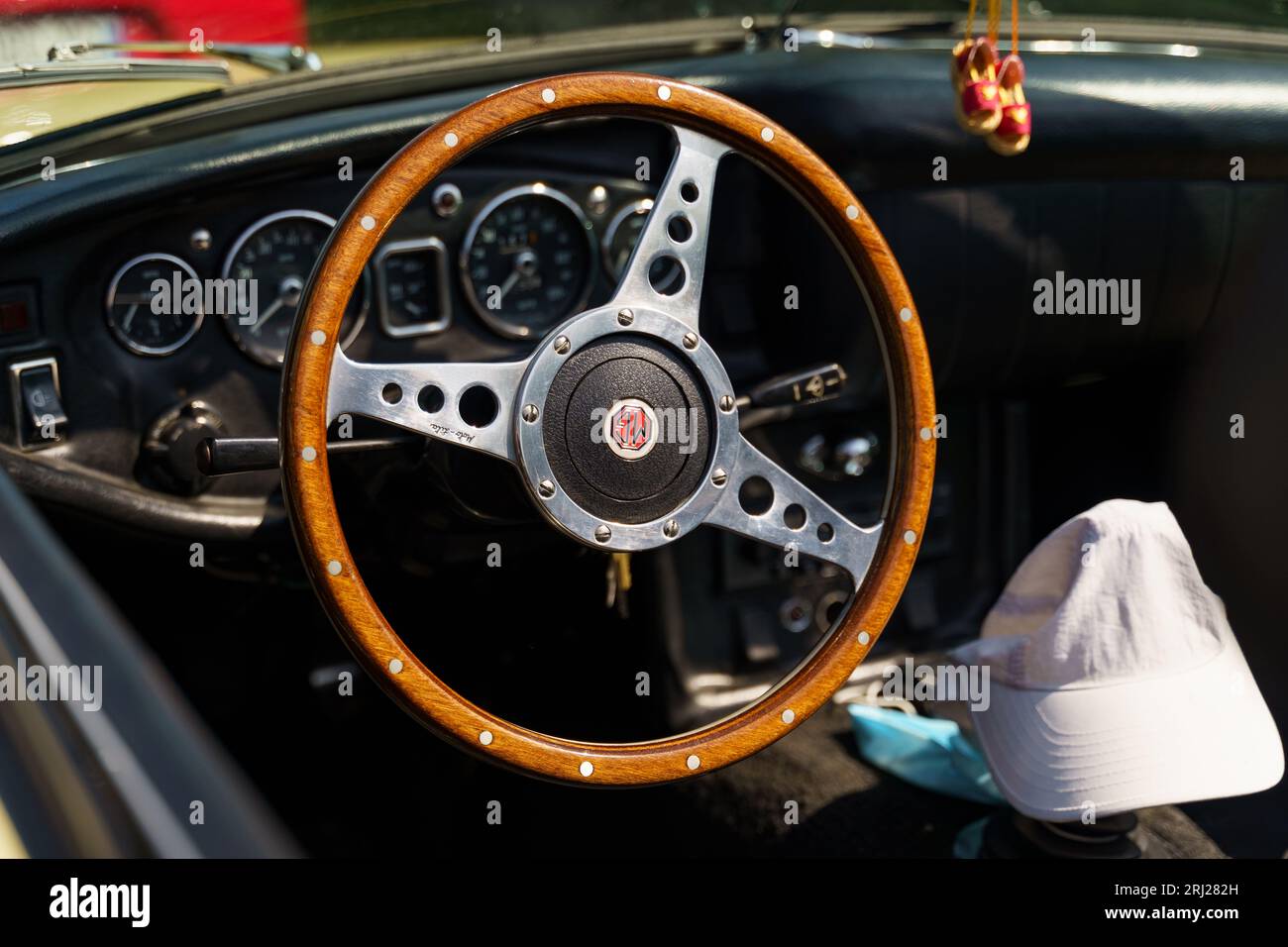 Langeac, France - May 27, 2023: Photo of vintage car Morris 1966 Morris Garage MGB Park 1 Roadster. Cockpit view of the vintage steering wheel. Stock Photo