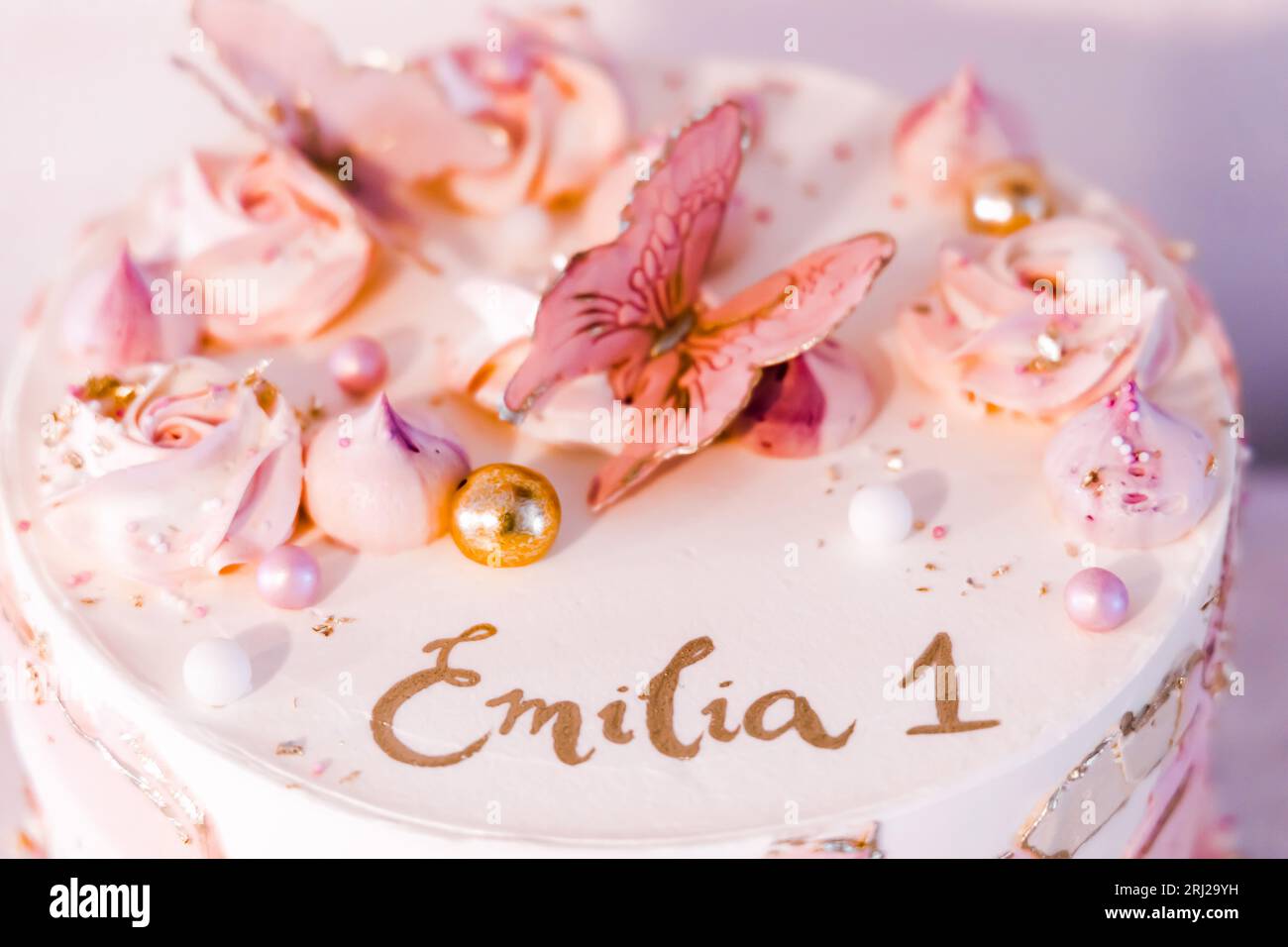 Birthday cake decorated with pink sugar flowers and butterflies Stock ...