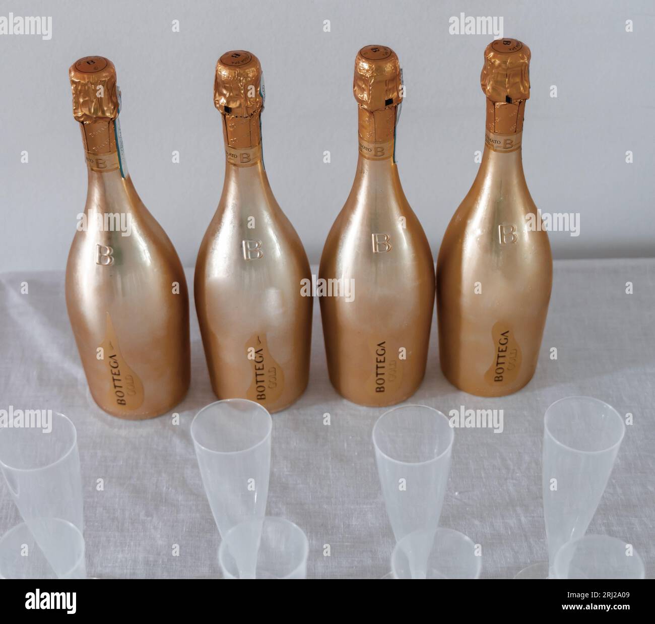 Bottega Champagne bottles and plastic champagne glasses. Celebrating an