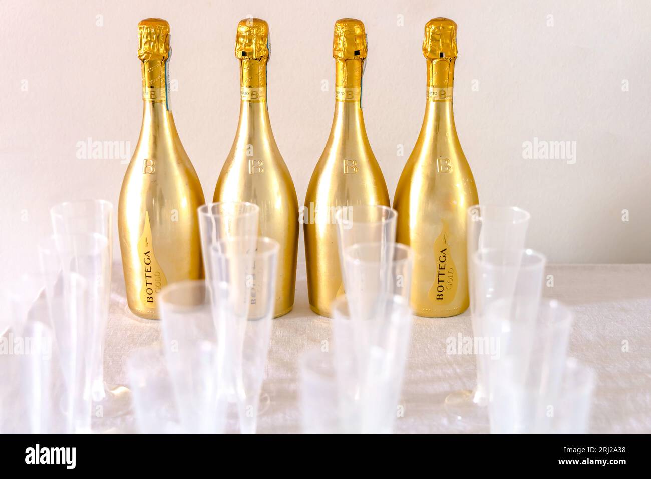 Bottega Champagne bottles and plastic champagne glasses. Celebrating an