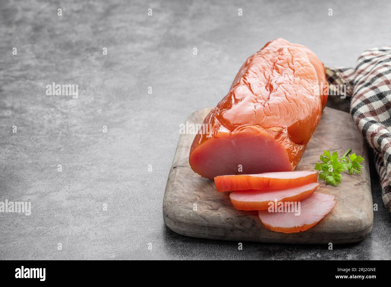 Dried  chicken breast on wooden board on gray background Stock Photo